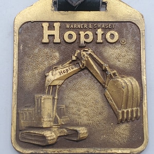 ANTIQUE HOPTO WARNER & Swasey Pocket Watch Fob Excavator Construction Machinery in orginal package Collectible Advertising Memorabilia