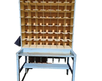May include: A vintage blue wooden mail sorter with multiple compartments. The sorter has a table and a bench. The compartments are made of light brown wood. The piece has a distressed look.