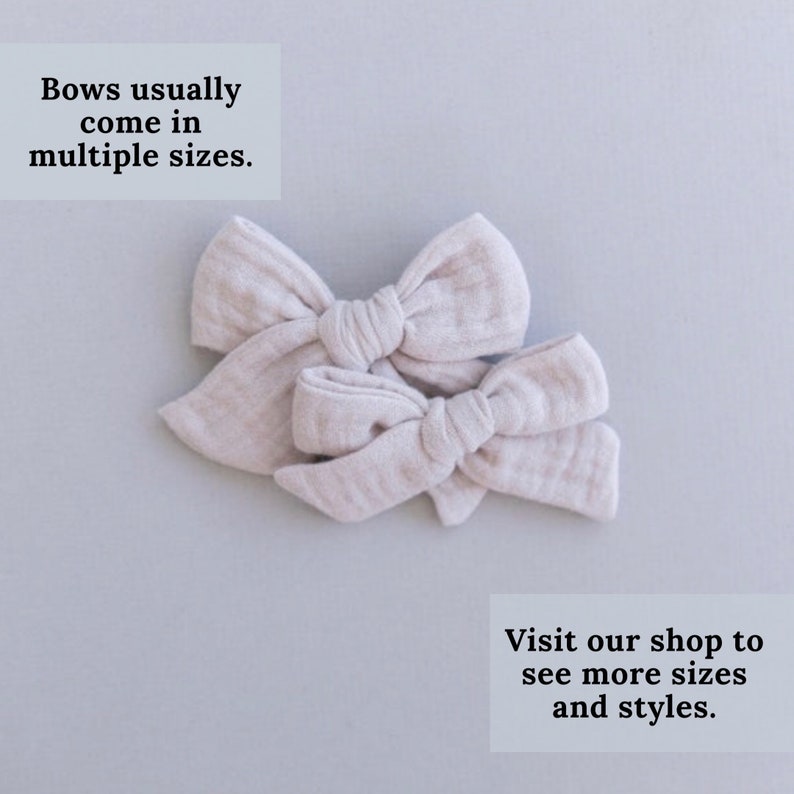 May include: Two beige fabric hair bows of different sizes. The bows are tied together in the center. The text "Bows usually come in multiple sizes. Visit our shop to see more sizes and styles." is printed below the bows.