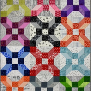 May include: A patchwork quilt with a variety of colourful fabrics. The quilt is made up of 12 squares, each with a different pattern. The patterns include polka dots, stripes and geometric shapes. The quilt is a great example of traditional quilting techniques.