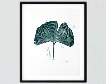 May include: A framed print of a green ginkgo leaf, a botanical illustration with a white background.