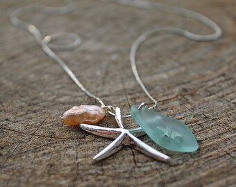 May include: A silver chain necklace with a light pink pearl, a silver starfish charm, and a light blue sea glass pendant.
