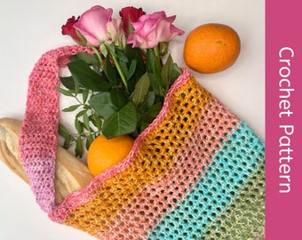 May include: A colorful, crocheted tote bag filled with fresh produce and flowers. The bag is a gradient of pink, yellow, and blue. The bag contains roses, oranges, and a loaf of bread. The text "Crochet Pattern" is on the right side.