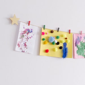 Kids art display with gold stars and colourful clothespegs, Easy fit childrens art work hanger image 1