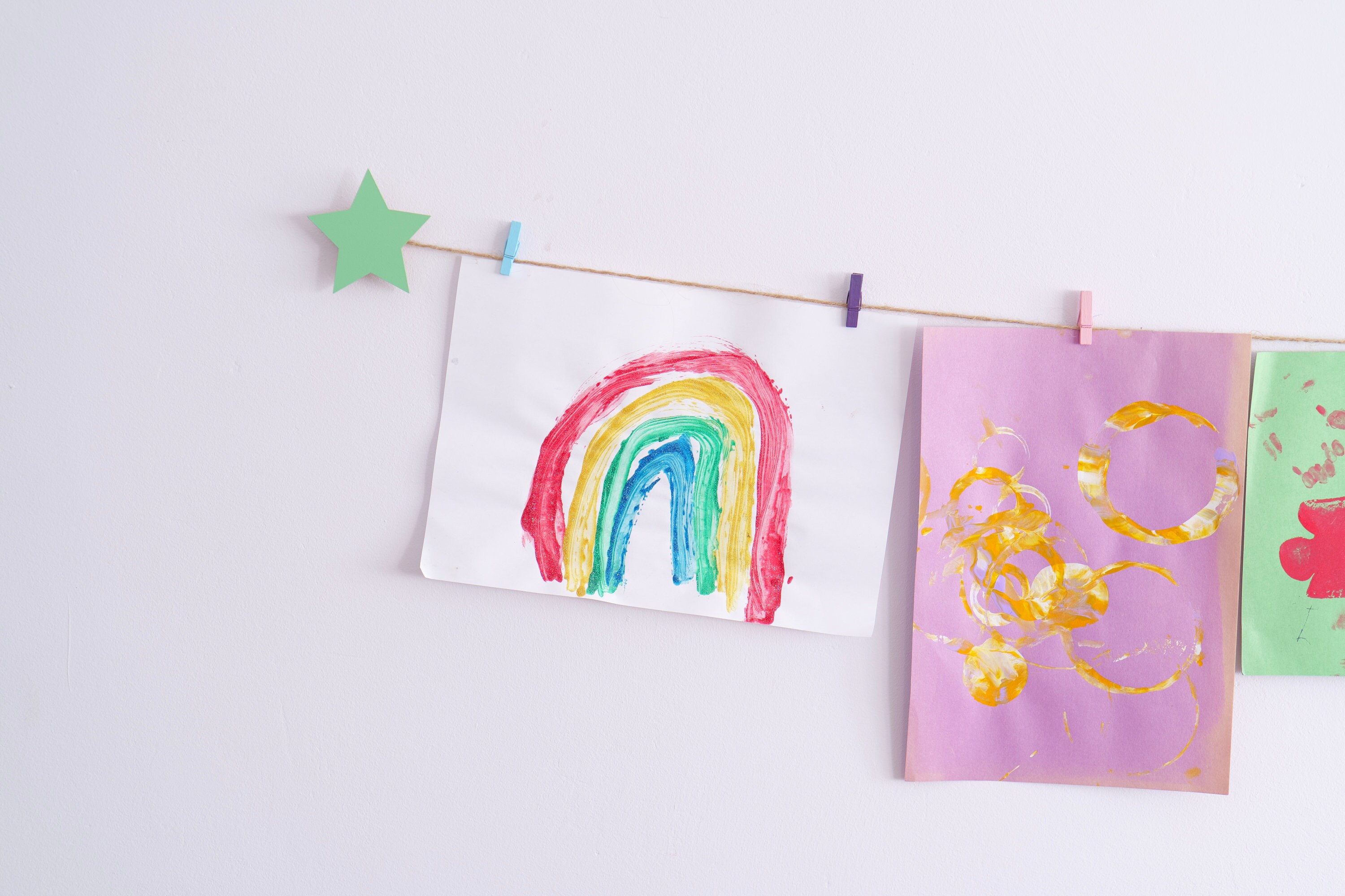 Kids art display with mint green stars and colourful clothespegs, Easy fit childrens art work hanger