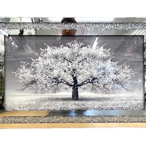 May include: A rectangular wall art piece featuring a black and white image of a tree with white blossoms. The frame is constructed with a wide, textured border filled with small, reflective silver-toned crushed glass pieces that catch the light.