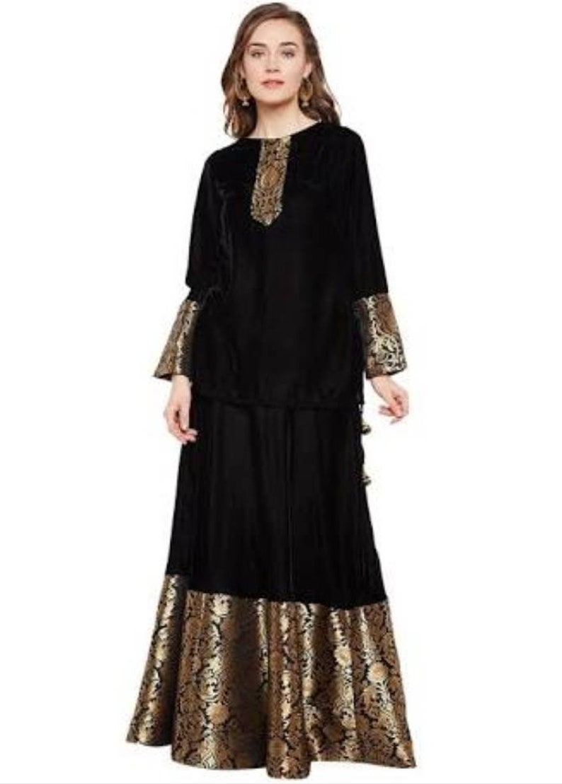 May include: A black velvet top with gold embroidery and matching skirt. The skirt has a gold brocade trim.
