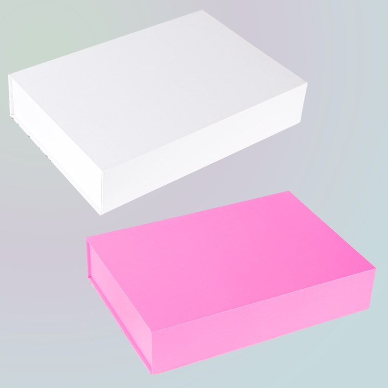 May include: Two rectangular gift boxes, one white and one bright pink, are displayed against a soft gray background. The boxes have a clean, minimalist design with a magnetic closure. The white box is positioned above the pink box.