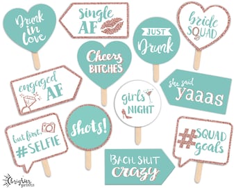 May include: A set of 12 teal and rose gold glitter photo booth props with various sayings for a bachelorette party. The props include "Drunk in love", "Single AF", "Cheers Bitches", "Just Drunk", "Bride Squad", "Engaged AF", "But first, #Selfie", "Shots!", "She said Yaaas", "Girls Night", "#Squad Goals", and "Bach Shit Crazy".