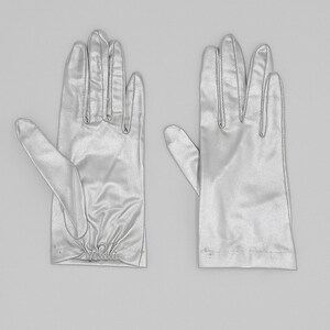 collector of vision deadstock metallic silver gloves in a size XS. Elastic pleated detail on the bottom of the wrist area. An elegant glove that would be perfect for your wedding.