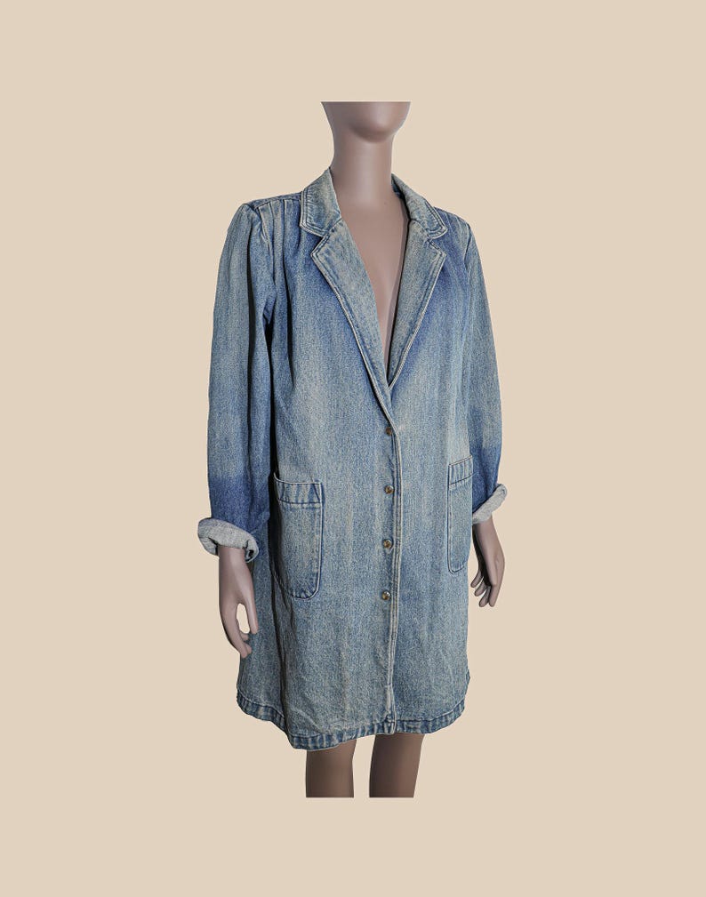 May include: A long, light blue denim jacket with a button-up front and two patch pockets. The jacket has a classic collar and long sleeves.