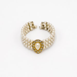 collector of vision wedding faux white pearl stacked bracelet with a teardrop center and gold plated setting