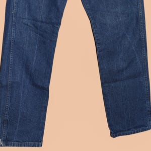 May include: A pair of dark blue denim jeans with a straight leg fit.
