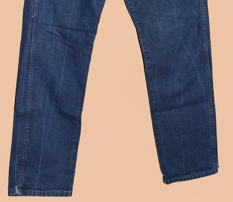 May include: A pair of dark blue denim jeans with a straight leg fit.