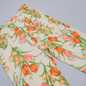 70s floral printed pants showing off the back