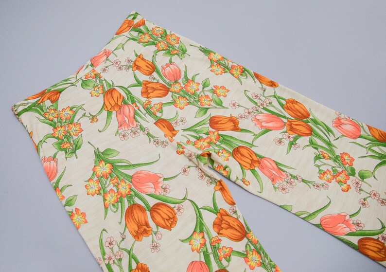70s floral printed pants showing off the back