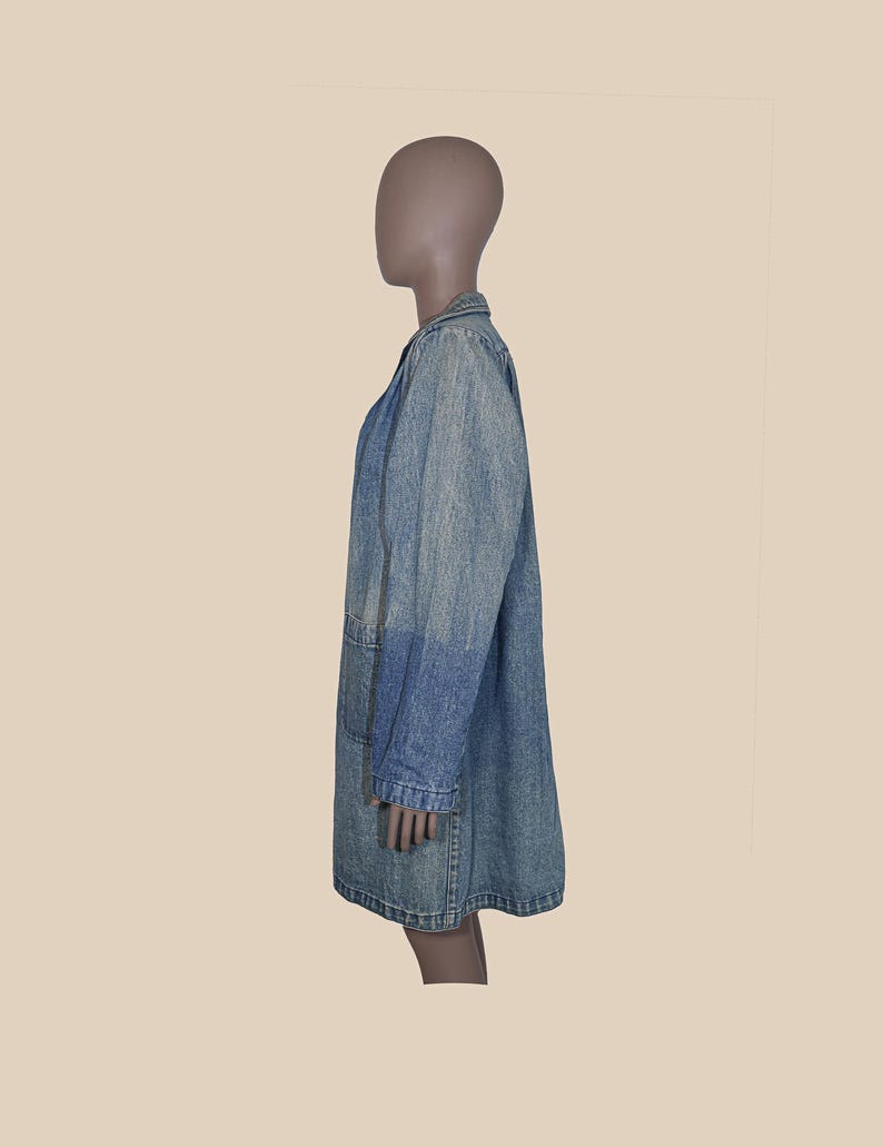 May include: A long denim jacket with a collar and long sleeves. The jacket is a light blue color and has a faded look.
