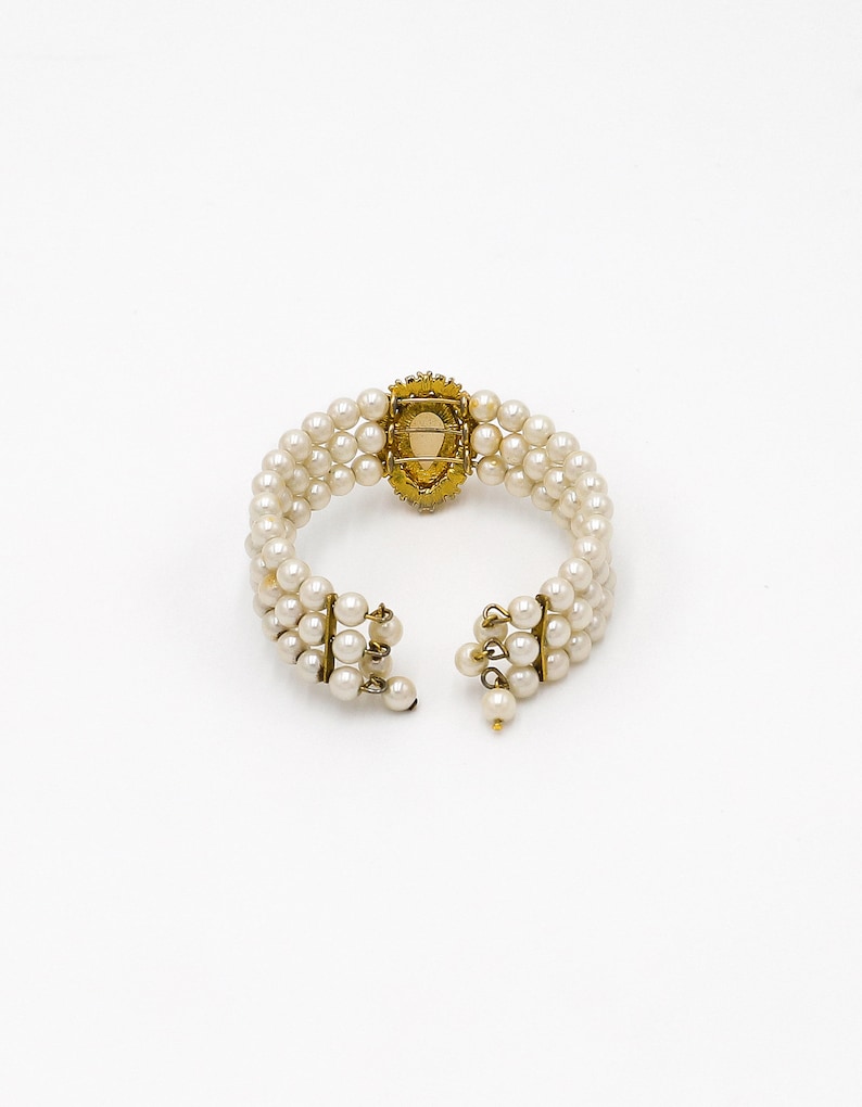 collector of vision wedding faux white pearl stacked bracelet with a teardrop center and gold plated setting with round dangling pearl opening