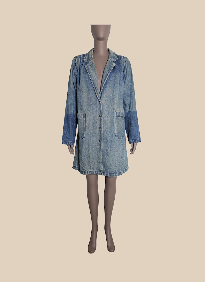 May include: A long, light blue denim jacket with a button closure and two front pockets.