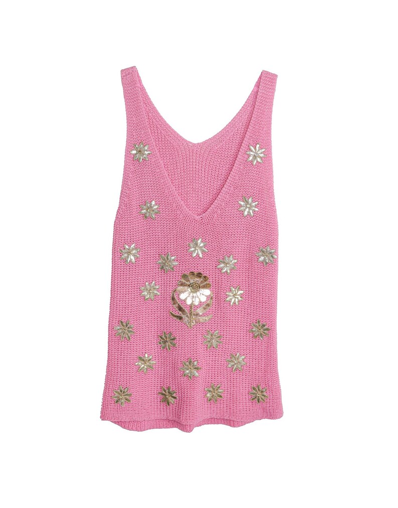 K&ouml;nnte beinhalten: Ein pinkfarbenes, &auml;rmelloses Stricktop mit V-Ausschnitt und goldenen Blumenverzierungen.