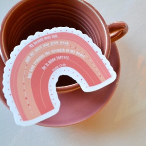 May include: A pink and orange rainbow sticker with the text "My health may fail, and my spirit may grow weak, but God remains the strength of my heart; He is mine forever. Psalm 73:26"