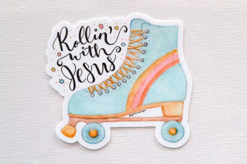 May include: A blue and orange roller skate with rainbow stripes and white laces. The text "Rollin' with Jesus" is written in black cursive on the skate.