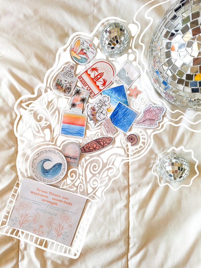 May include: A collection of colorful stickers with various designs, including a seashell, a surfboard, a bottle, and a palm tree. The stickers are arranged on a white surface with a white outline around them. There are two silver disco balls in the background.
