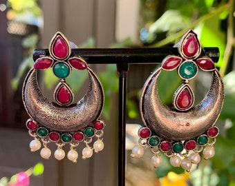 Vibrant magenta and green gemstone jhumki earrings with micro pearl detail