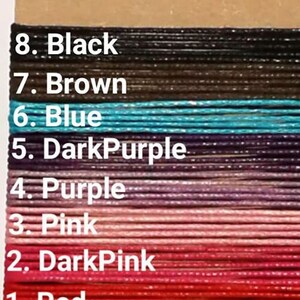 May include: A close-up of eight different colors of cord, labeled with numbers 1 through 8. The colors are red, dark pink, pink, purple, dark purple, blue, brown, and black.