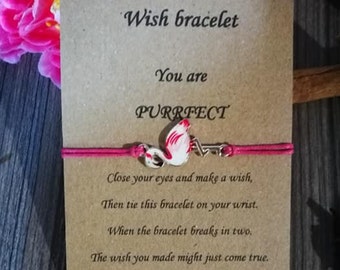 May include: Pink wish bracelet with a flamingo charm and the text "You are PURRFECT. Close your eyes and make a wish, Then tie this bracelet on your wrist. When the bracelet breaks in two. The wish you made might just come true. Handcrafted with love."
