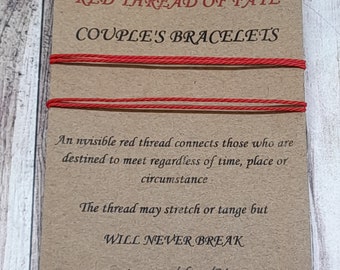 May include: Two red string bracelets on a brown card with the text "Red Thread of Fate Couple's Bracelets". The card also includes the text "An invisible red thread connects those who are destined to meet regardless of time, place or circumstance. The thread may stretch or tangle but WILL NEVER BREAK. www.etsy.com/shop/Megyart"