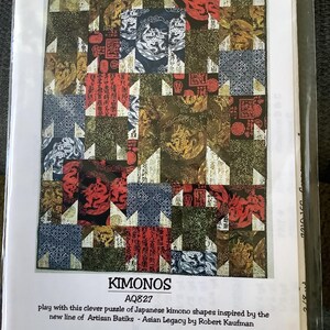 May include: A quilt pattern titled "Kimonos" featuring a patchwork design with Japanese kimono shapes. The quilt incorporates various colors, including red, blue, and gold, with the text "AARDVARK QUILTS" at the bottom.