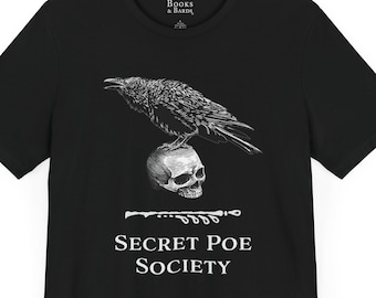 May include: Black t-shirt featuring a white graphic of a raven perched on a skull. The text "Secret Poe Society" is printed below the graphic.