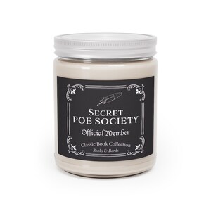 May include: A beige candle jar with a black and white label that reads "Secret Poe Society Official Member Classic Book Collection Books & Bards".