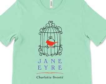 May include: A mint green t-shirt with a black silhouette of a bird in a cage. The text "JANE EYRE" is printed in blue below the cage, and "Charlotte Brontë" is printed in black below the text.
