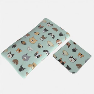 May include: Two rectangular fabric pouches with a light blue background and a repeating pattern of various dog breeds. The pouches are made of a soft, durable fabric and are ideal for storing small items.
