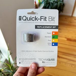 May include: A silver replacement bit for a Quick-Fit Bit drill. The bit is labeled "Rapid", "Standard", "Fine", and "Ultra Fine". The bit holder diameter is 3/4 inch (19 mm) or 1 inch (25 mm). The packaging is labeled "Techniglass" and "Made in the USA".