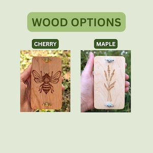 May include: The image displays two rectangular wooden items, labeled "Cherry" and "Maple." The cherry wood features a detailed bee engraving, while the maple wood showcases a plant design. Both have metal hardware.