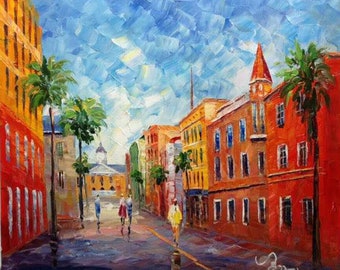 May include: A colorful oil painting of a street scene with buildings in shades of red, yellow, and orange. Palm trees line the street, and there are people walking on the sidewalk.