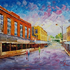 May include: A painting of a street scene with buildings on both sides of the street. The buildings are painted in a variety of colors, including orange, yellow, and blue. The sky is painted in shades of blue and pink. There are people walking on the sidewalk and cars driving down the street. The painting is signed in the bottom right corner.