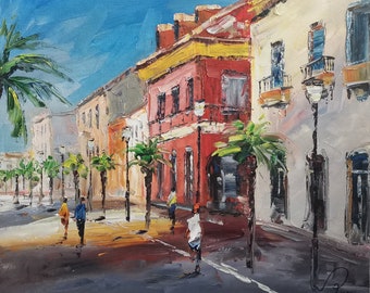 May include: Oil painting of a sunny street scene with buildings in shades of red, yellow, and white. Palm trees line the street, and figures are walking on the sidewalk. The sky is a bright blue.
