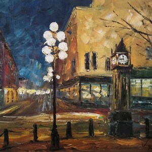 May include: Oil painting of a city street at night. The artwork features a clock tower, streetlights, and buildings with warm, inviting light. The color palette includes blues, yellows, and browns, creating a cozy, atmospheric scene.