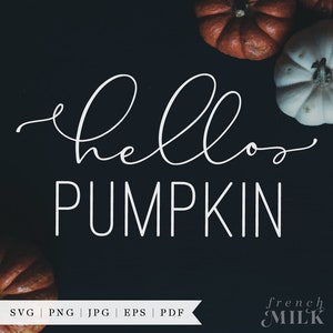 May include: White text on a black background reads "hello pumpkin".  The text is in a cursive font.  There are three pumpkins in the background, two orange and one white.