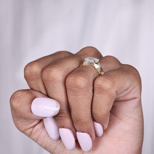 May include: A set of three ceramic mugs with a speckled, matte finish. The mugs are in shades of cream, light gray, and dark gray. Each mug has a simple, minimalist design, perfect for coffee or tea.