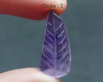 May include: A carved amethyst leaf pendant in a purple hue. The leaf has a detailed vein pattern carved into the surface. Code: I