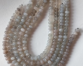 May include: A strand of gray moonstone beads, strung on thin wire, with a subtle shimmer. The beads are round and slightly irregular in shape.