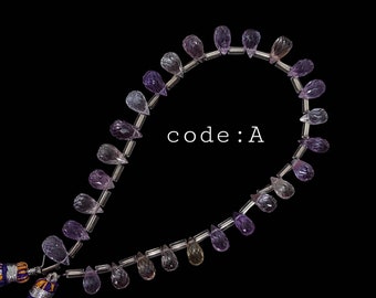 May include: A strand of purple and clear teardrop-shaped beads with silver spacers. The beads are strung on a silver wire and have a tassel on one end. The text "code: A" is visible in the image.