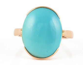 May include: A turquoise gemstone ring with a gold setting.