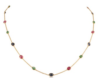 May include: A gold chain necklace with oval-shaped gemstones in shades of blue, green, and red.