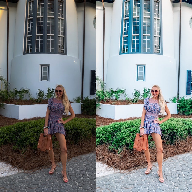 May include: A woman wearing a floral dress and sunglasses is standing in front of a white building with a large window. She is holding a brown handbag.